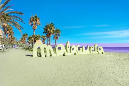 Malaga sign built in sand, car hire by easyCar