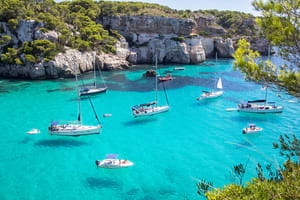 Boats in the sea off Menorca, car hire by easyCar